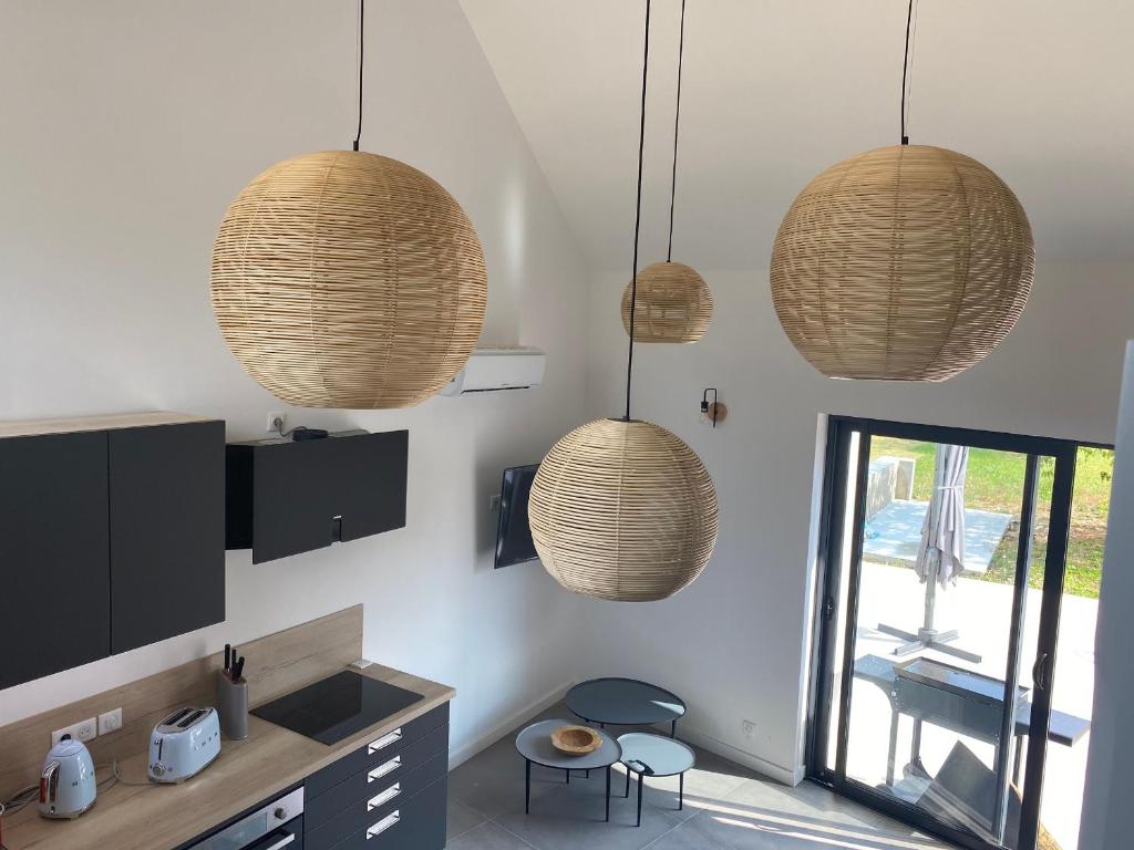 a kitchen with three hanging baskets on the wall at Maison rénovée en Berry : terrasse, jardin privé, proche Châteauroux et nature - FR-1-591-164 in Saint-Maur
