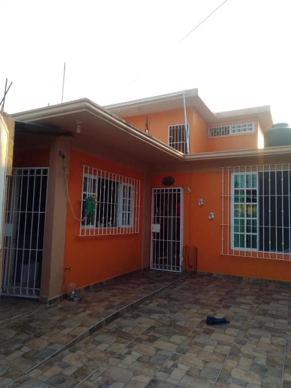 an orange house with bars on the front of it at Casa Vacacional Catemaco in Catemaco