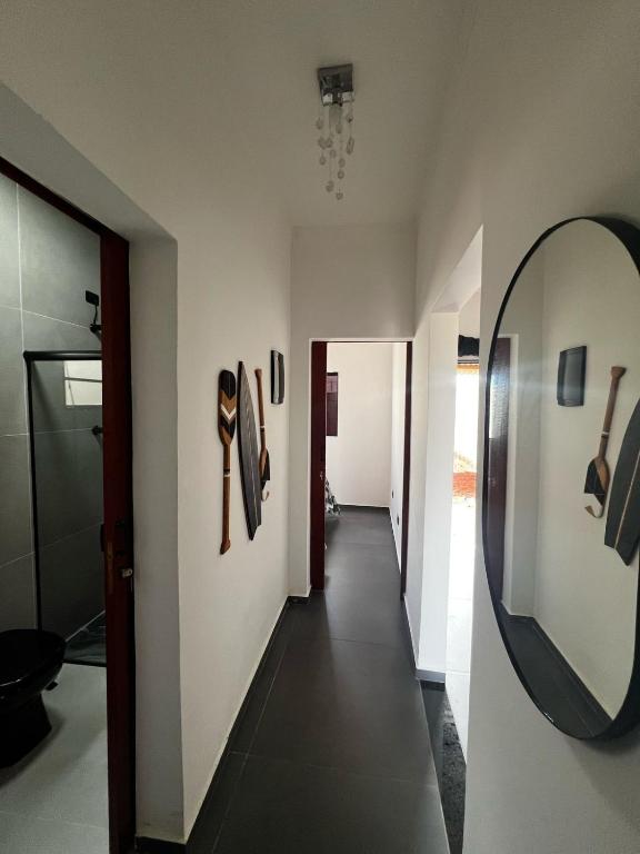 a hallway with a mirror on the wall and a hallway with a hallway at Casa Planalto in Piraju