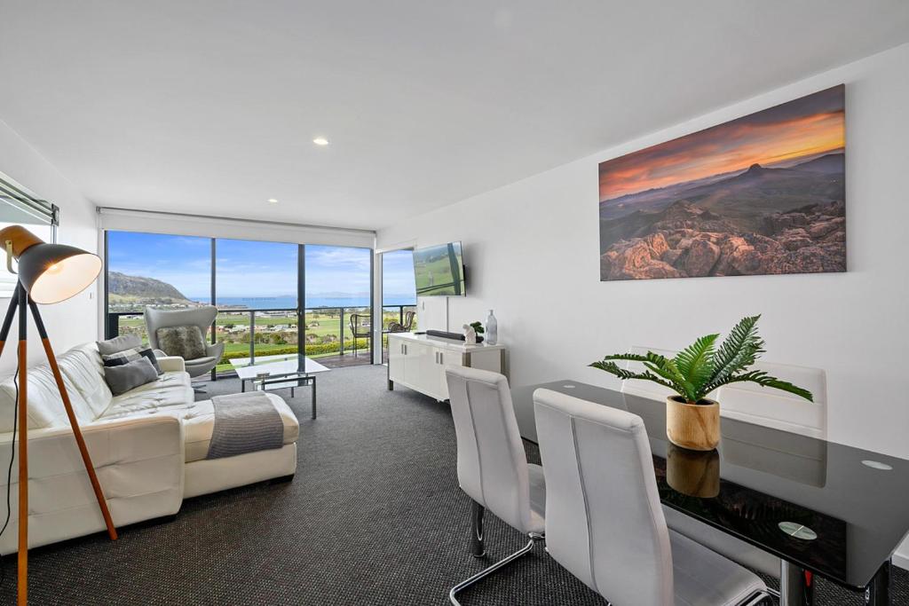 a bedroom with a bed and a desk with a television at Horizon Deluxe Apartments in Stanley