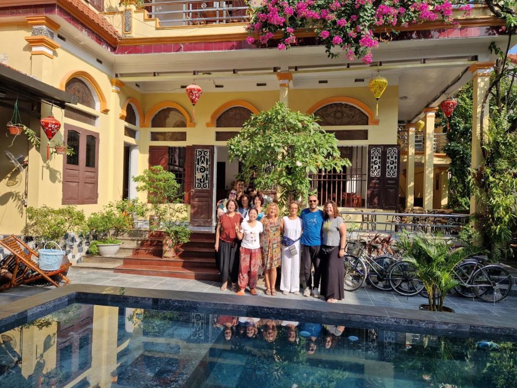 a group of people standing in front of a house at Tam Coc Family Hotel in Ninh Binh