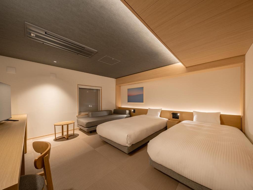 Postel nebo postele na pokoji v ubytování Dansetsu Sapporo - Opening in Apr 2025