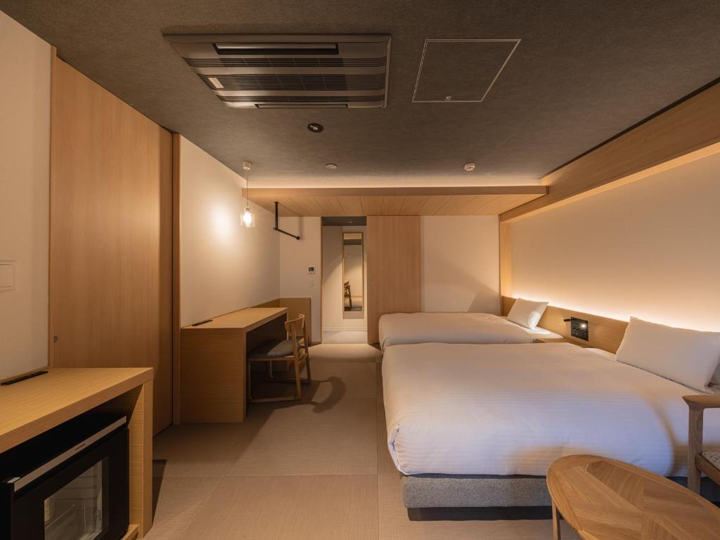 Postel nebo postele na pokoji v ubytování Dansetsu Sapporo - Opening in Apr 2025