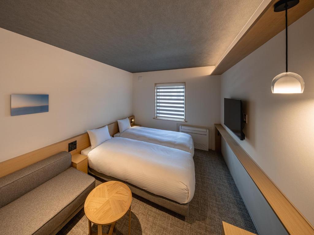 Postel nebo postele na pokoji v ubytování Dansetsu Sapporo - Opening in Apr 2025