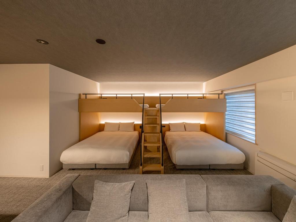 Postel nebo postele na pokoji v ubytování Dansetsu Sapporo - Opening in Apr 2025