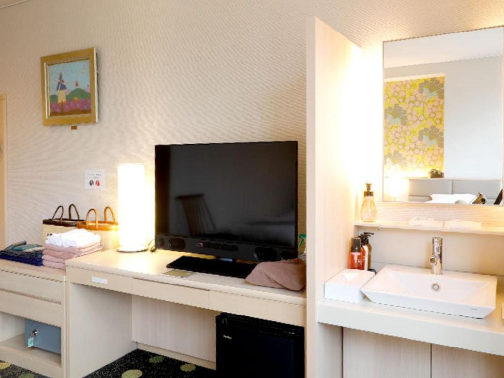 TV a/nebo společenská místnost v ubytování Arima Hot Spring Ryokan Kotori