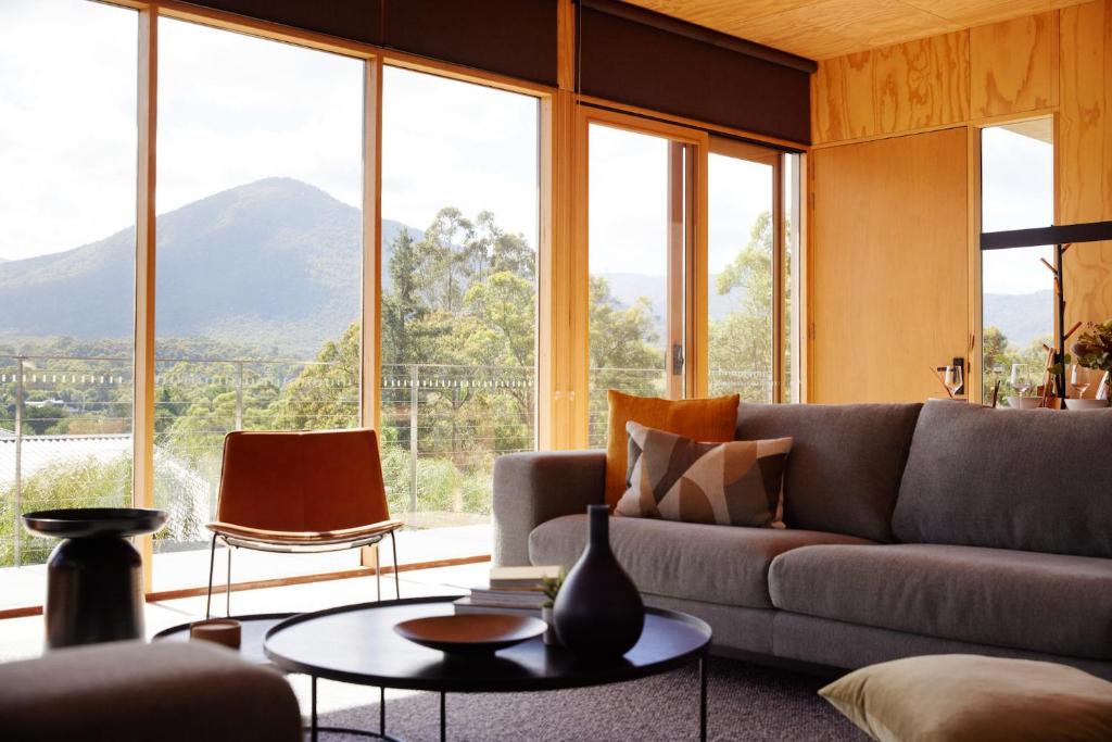 a living room with a couch and a table at Jacquina - Yarra Valley in Healesville