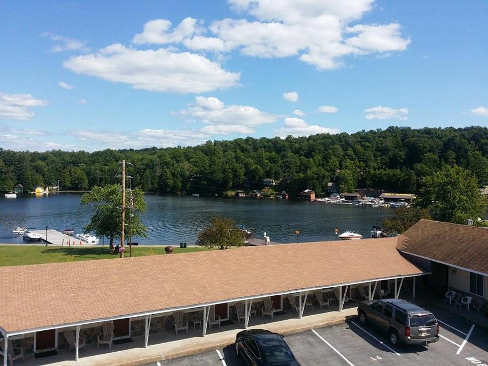 a view of a lake from a parking lot at Clark's Beach Motel in Old Forge