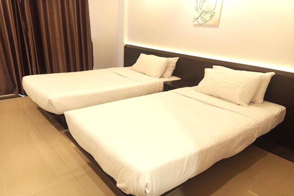 Postel nebo postele na pokoji v ubytování Smile Place Hotel Chiang Rai