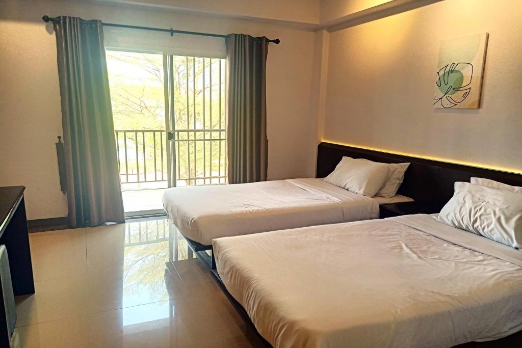 Postel nebo postele na pokoji v ubytování Smile Place Hotel Chiang Rai