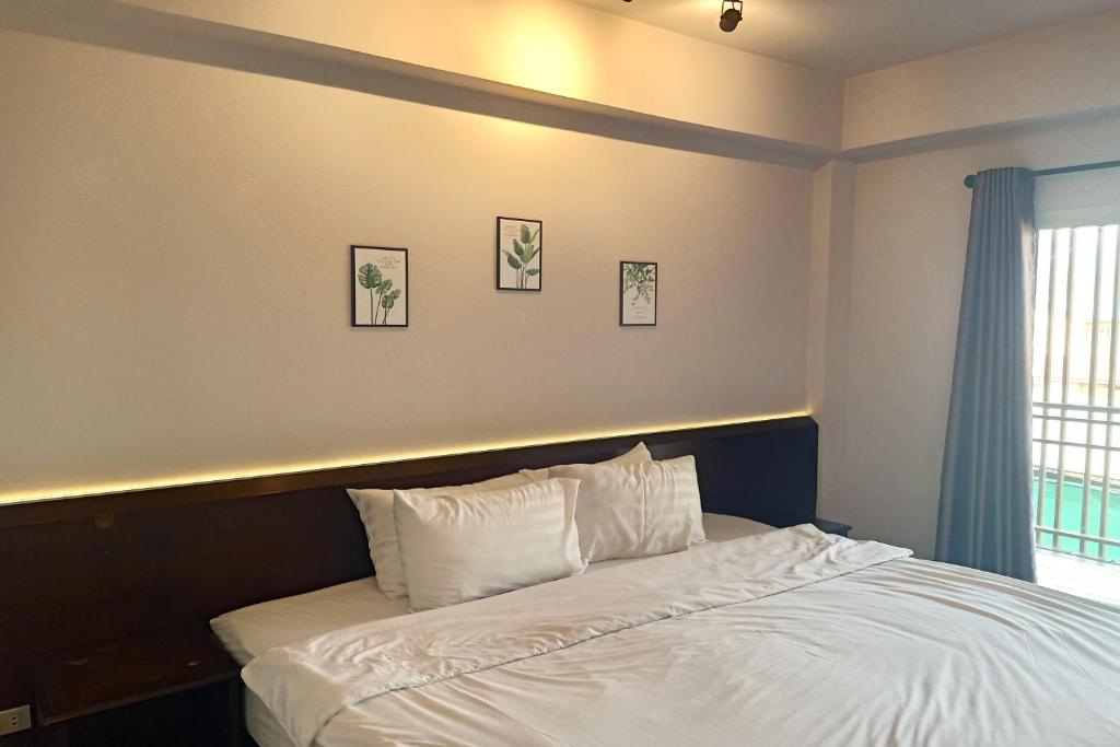 Postel nebo postele na pokoji v ubytování Smile Place Hotel Chiang Rai