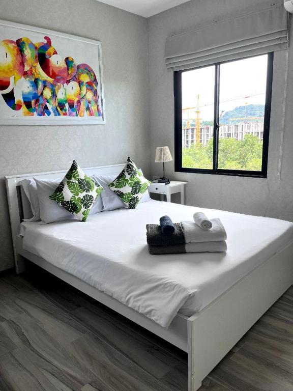 a large white bed in a bedroom with a window at B9 Ватсап669З5В2I976 in Nai Yang Beach