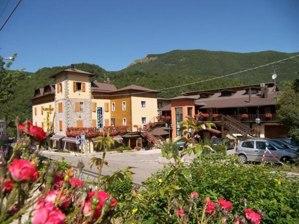 a group of buildings with flowers in front of them at Val Del Rio in Fiumalbo