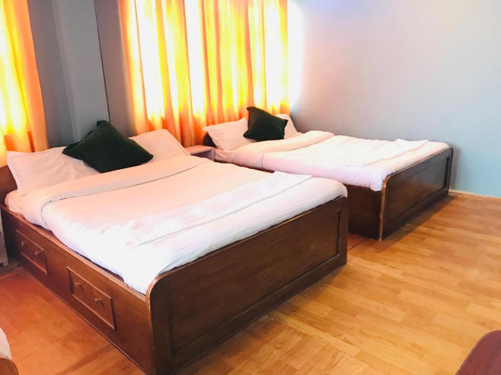 Postel nebo postele na pokoji v ubytování Mita Hotel