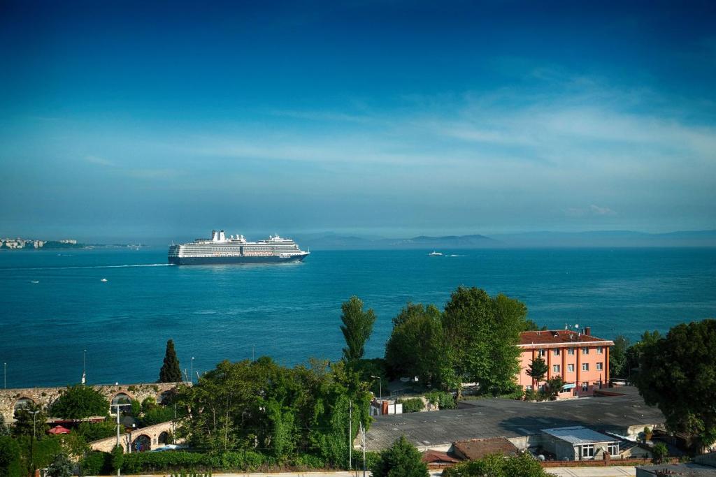 a large cruise ship floating in the water at Mytra Hotel in Istanbul
