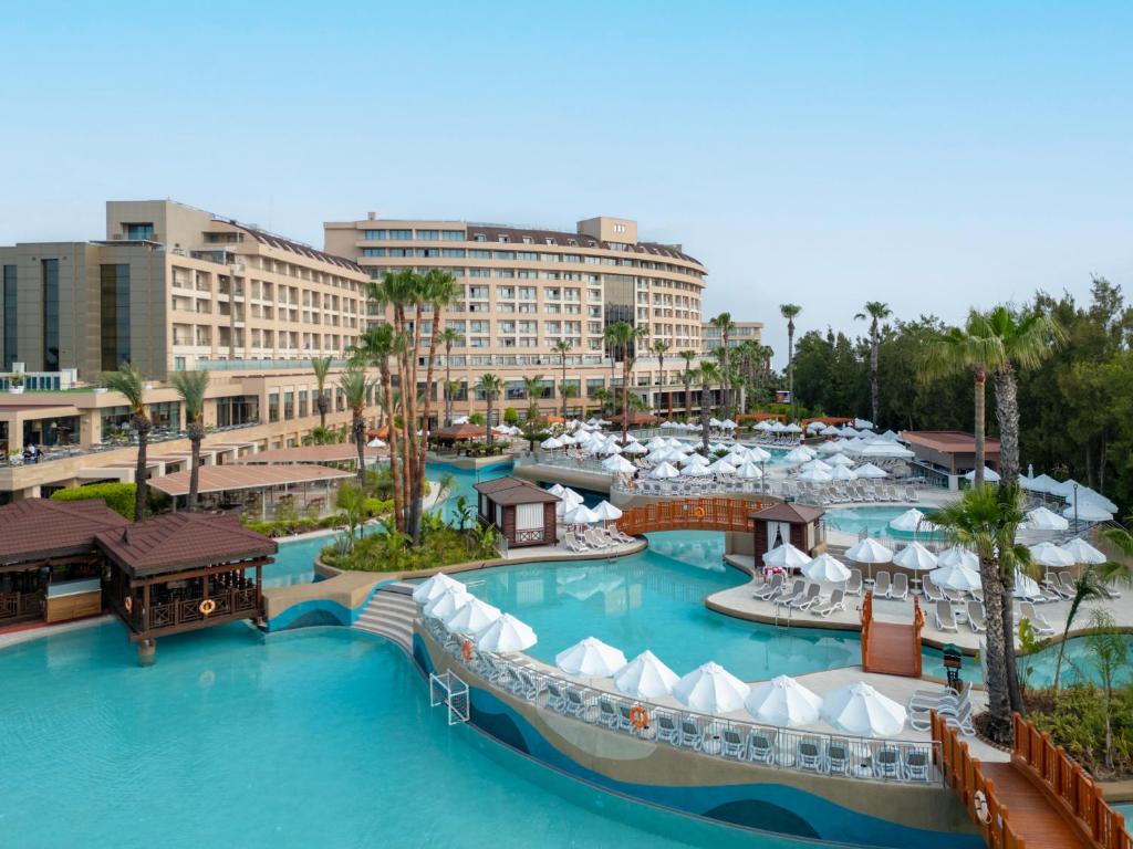 a resort with two pools and umbrellas at Fame Residence Lara & Spa in Lara