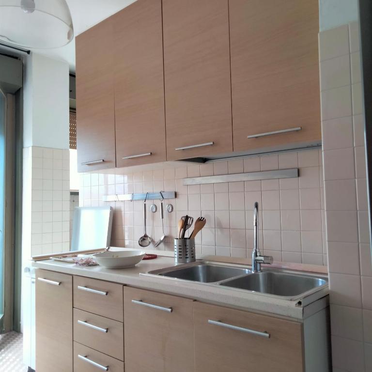 a kitchen with a sink and wooden cabinets at Carlo e Dani Flat in Venice in Venice