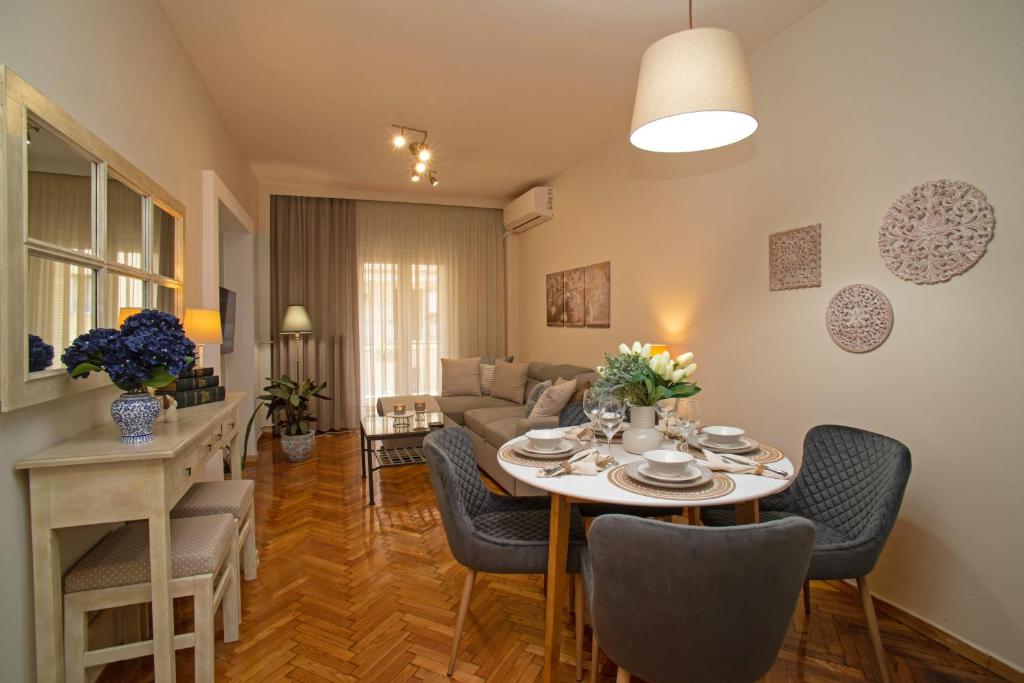 a living room with a table and a couch at Cozyhome 4 ILISIA in Thessaloniki
