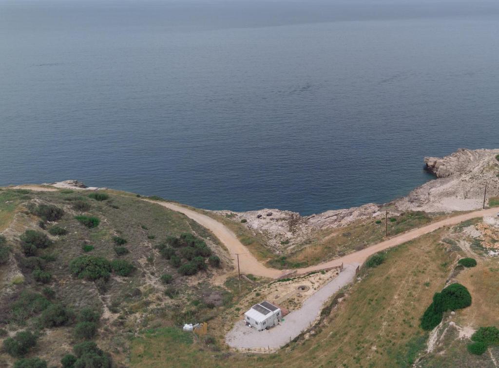 an aerial view of a camper on a hill near the ocean at Erato's Cottage in Plaka