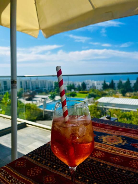 a drink with a striped straw sitting on a table at Retreat, Block A1, unit 6 in Küçükerenköy
