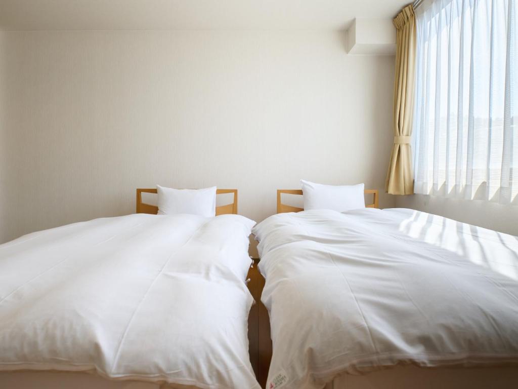 Postel nebo postele na pokoji v ubytování Owara View Hotel