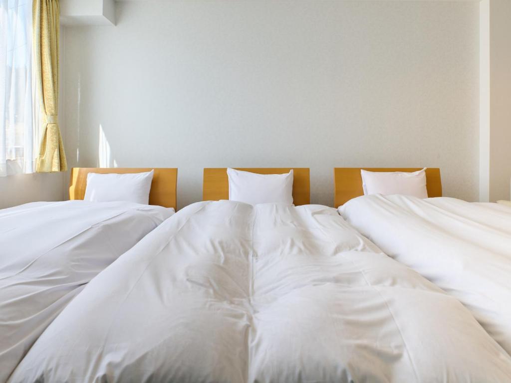 Postel nebo postele na pokoji v ubytování Owara View Hotel