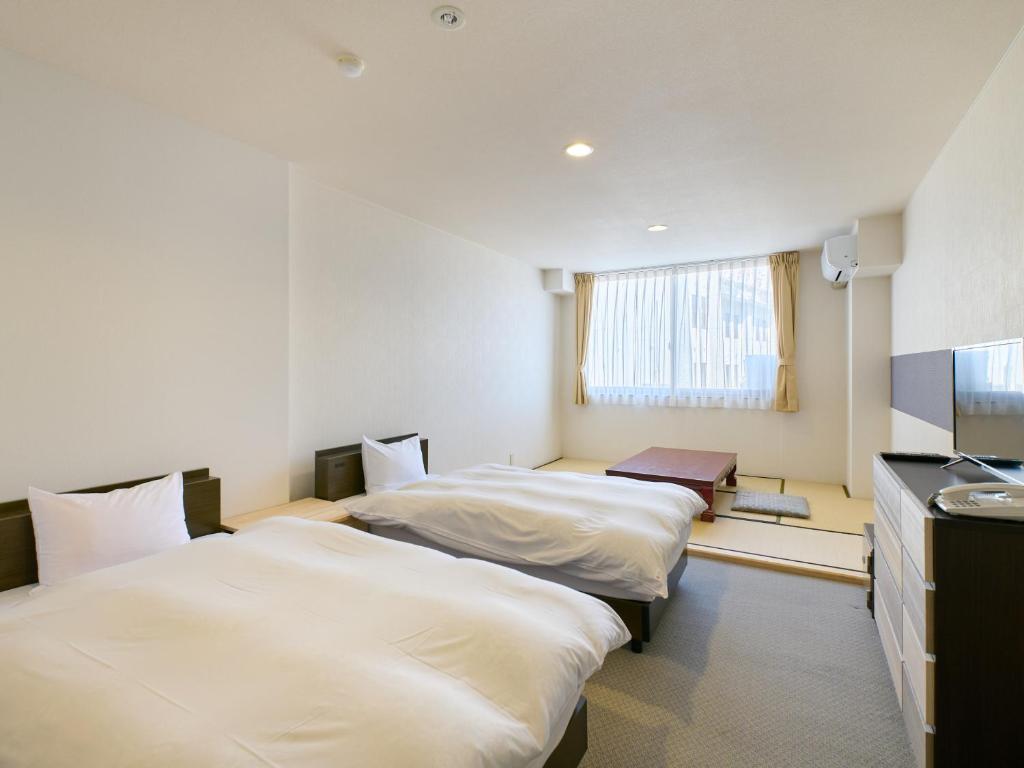 Postel nebo postele na pokoji v ubytování Owara View Hotel