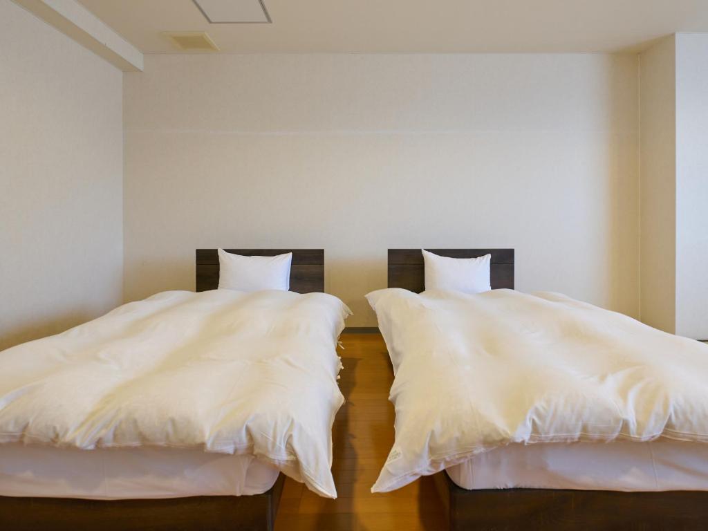 Postel nebo postele na pokoji v ubytování Owara View Hotel