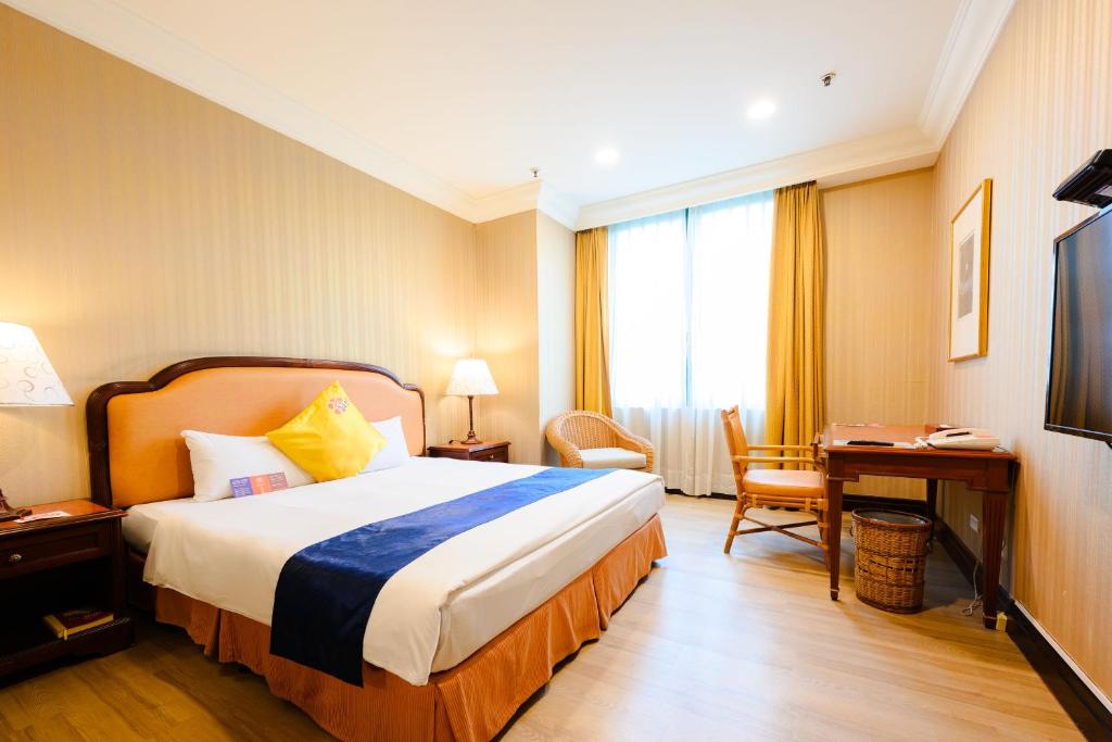 Postel nebo postele na pokoji v ubytování Wei-Yat Grand Hotel