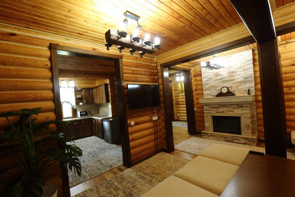 a hallway of a log cabin with a fireplace at Sherwood Resort in Bulaksu
