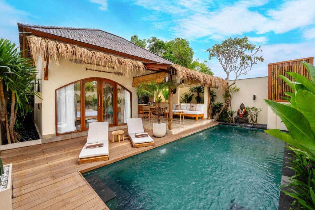 a villa with a swimming pool and a house at Villa Aldona by Pertama Stay in Tanah Lot