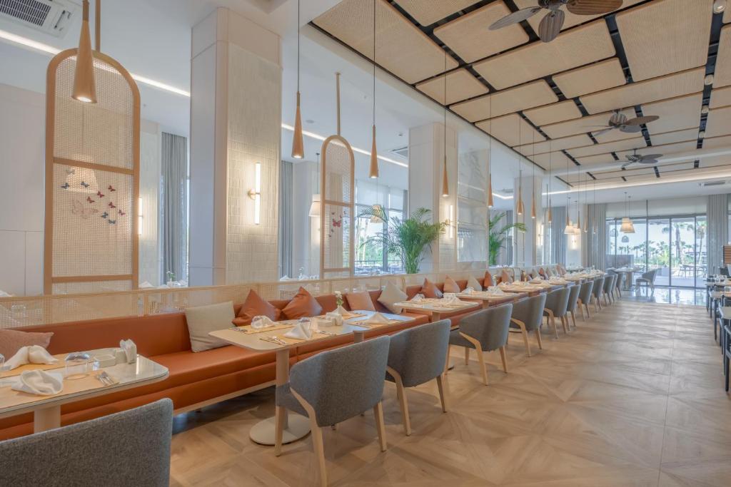a dining room with long tables and chairs at Fame Residence Lara & Spa in Lara