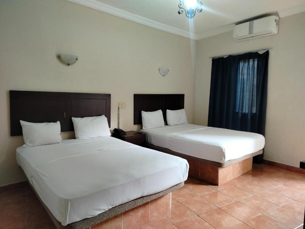 Postel nebo postele na pokoji v ubytování OYO Hotel Plaza Veracruz Centro Historico