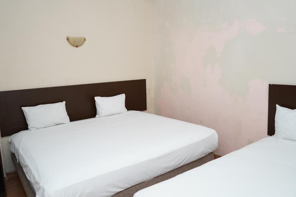 Postel nebo postele na pokoji v ubytování OYO Hotel Plaza Veracruz Centro Historico