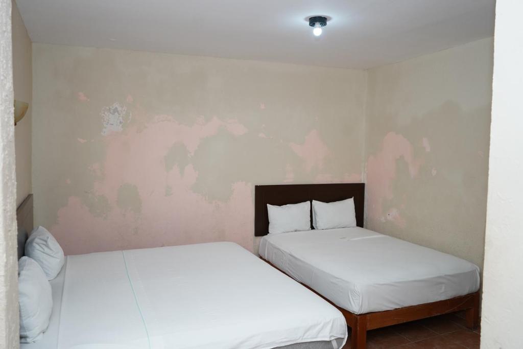 Postel nebo postele na pokoji v ubytování OYO Hotel Plaza Veracruz Centro Historico