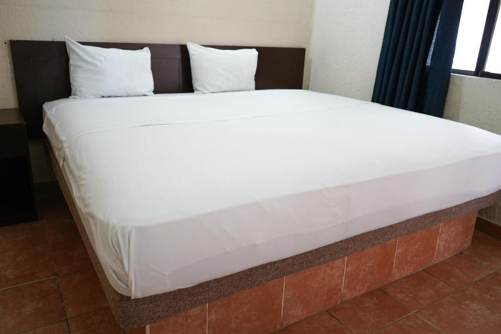 Postel nebo postele na pokoji v ubytování OYO Hotel Plaza Veracruz Centro Historico