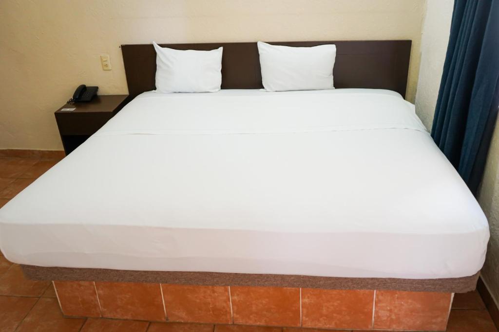 Postel nebo postele na pokoji v ubytování OYO Hotel Plaza Veracruz Centro Historico