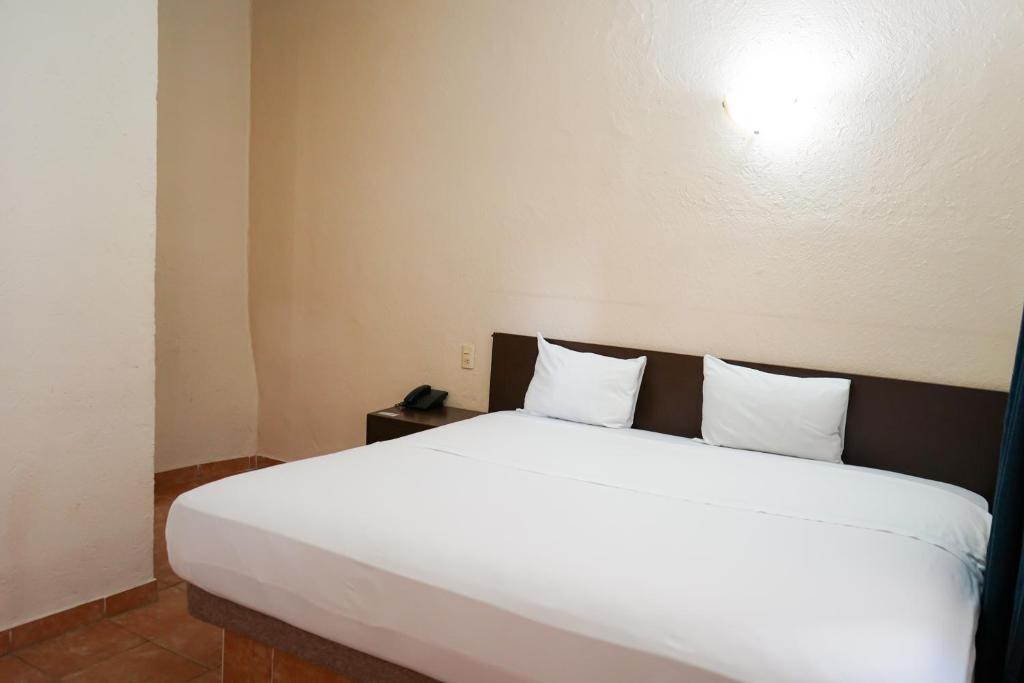 Postel nebo postele na pokoji v ubytování OYO Hotel Plaza Veracruz Centro Historico