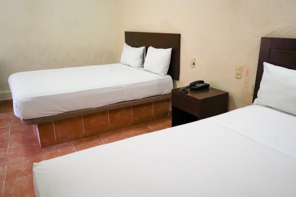 Postel nebo postele na pokoji v ubytování OYO Hotel Plaza Veracruz Centro Historico