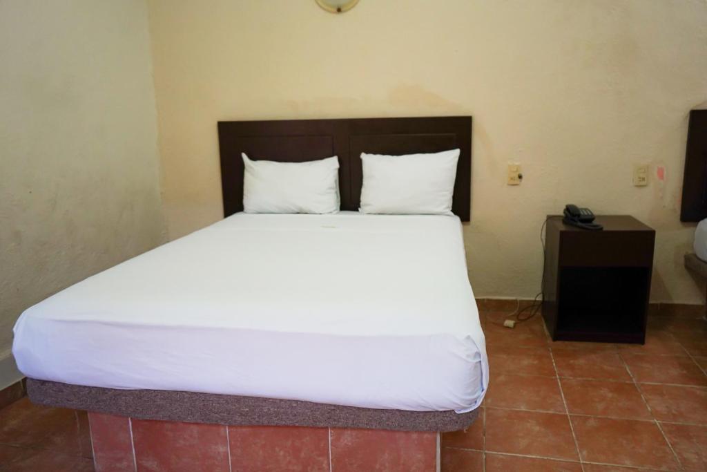 Postel nebo postele na pokoji v ubytování OYO Hotel Plaza Veracruz Centro Historico