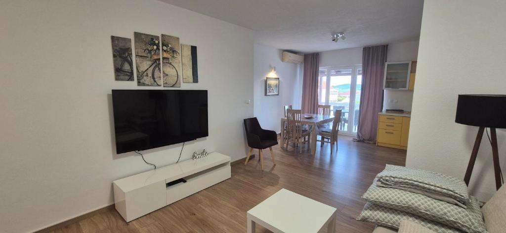 a living room with a flat screen tv on a wall at Apartment Magdalena in Sveti Filip i Jakov