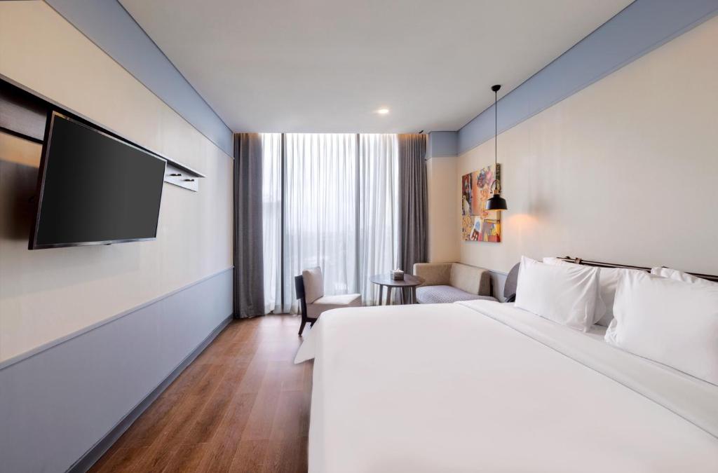 Postel nebo postele na pokoji v ubytování ARTOTEL Hub Simpang Temu Jakarta