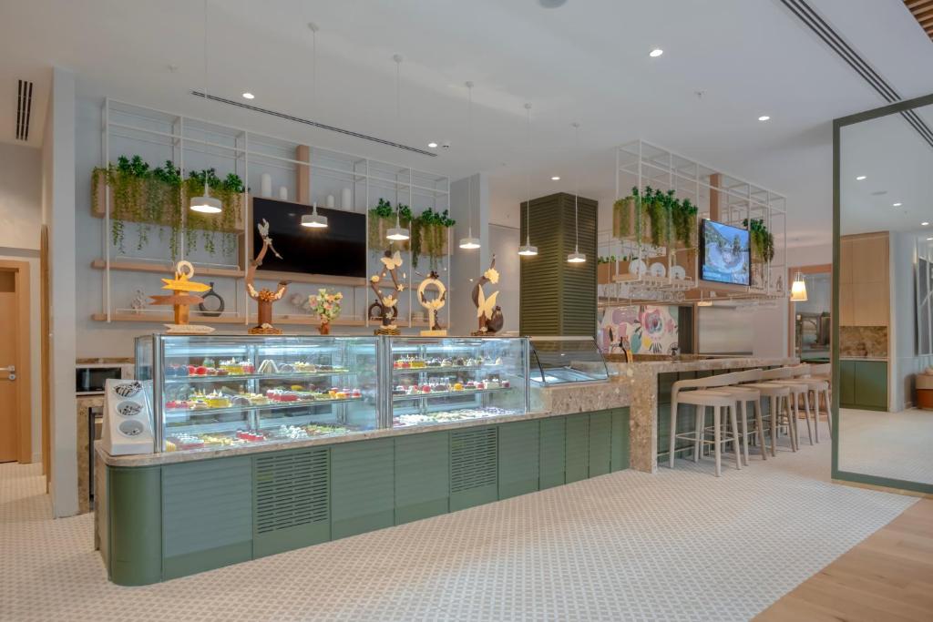 a candy store with a display case with desserts at Fame Residence Lara & Spa in Lara