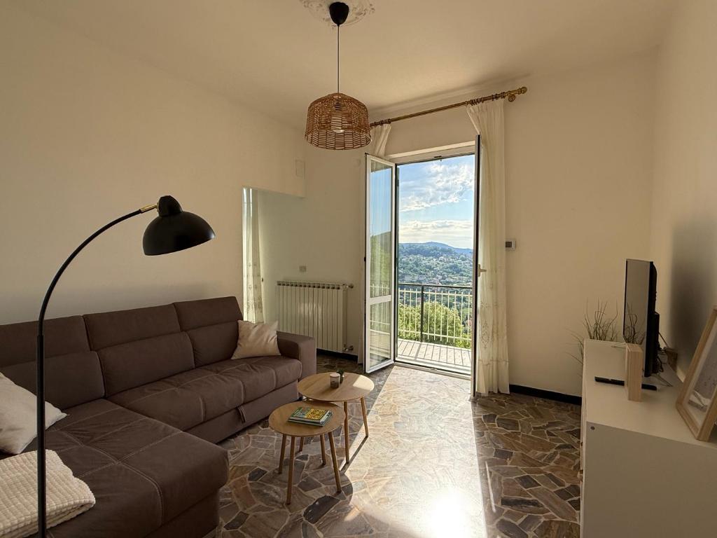 a living room with a couch and a large window at Appartamento Bellavista in San Martino