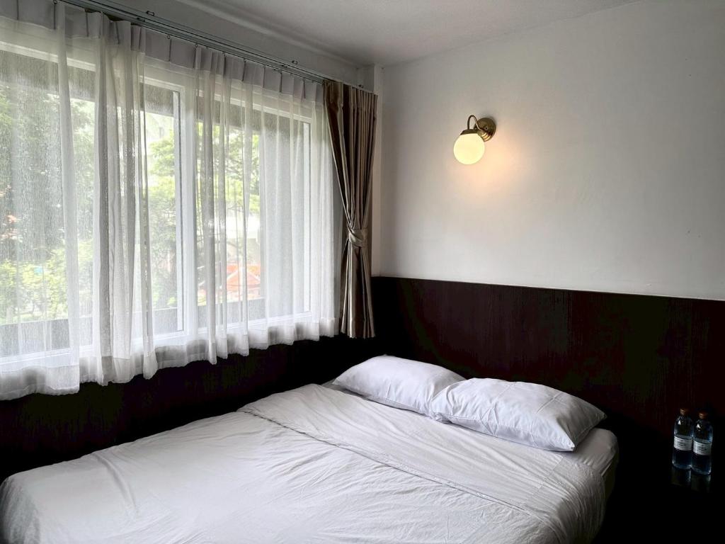 Postel nebo postele na pokoji v ubytování Four Sisters Homestay
