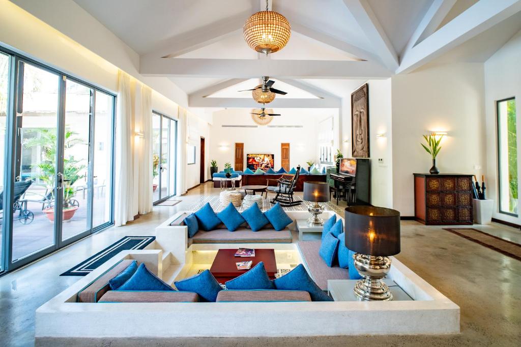 a living room with blue pillows and a couch at Coco Luxury Villa Mũi Né in Ấp Thiện Phước