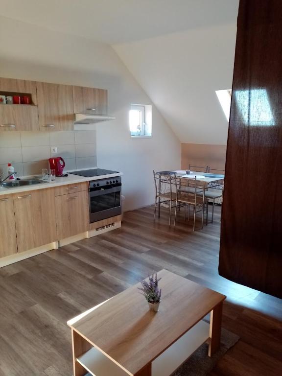 a kitchen and living room with a table in it at Apartmán Nicolass in Šakvice