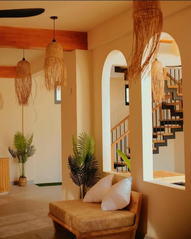 a living room with a couch and a staircase at Ruka Maldives in Dhiffushi