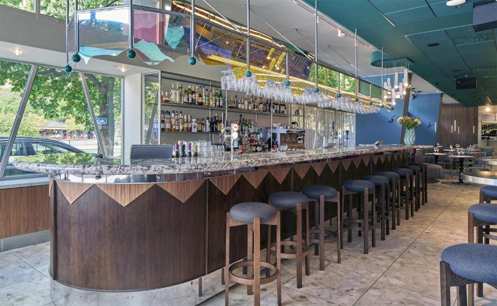 a bar in a restaurant with stools at Scandic Malmen in Stockholm