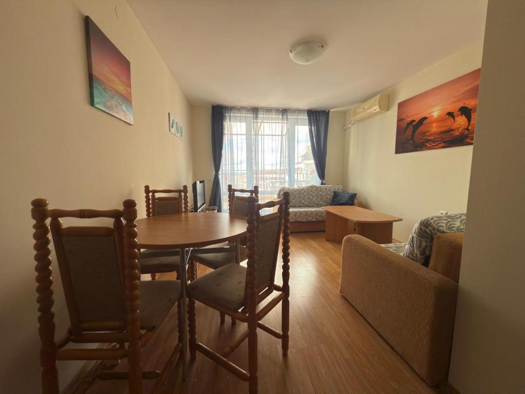 a living room with a table and chairs and a couch at Sea whisper in Elenite